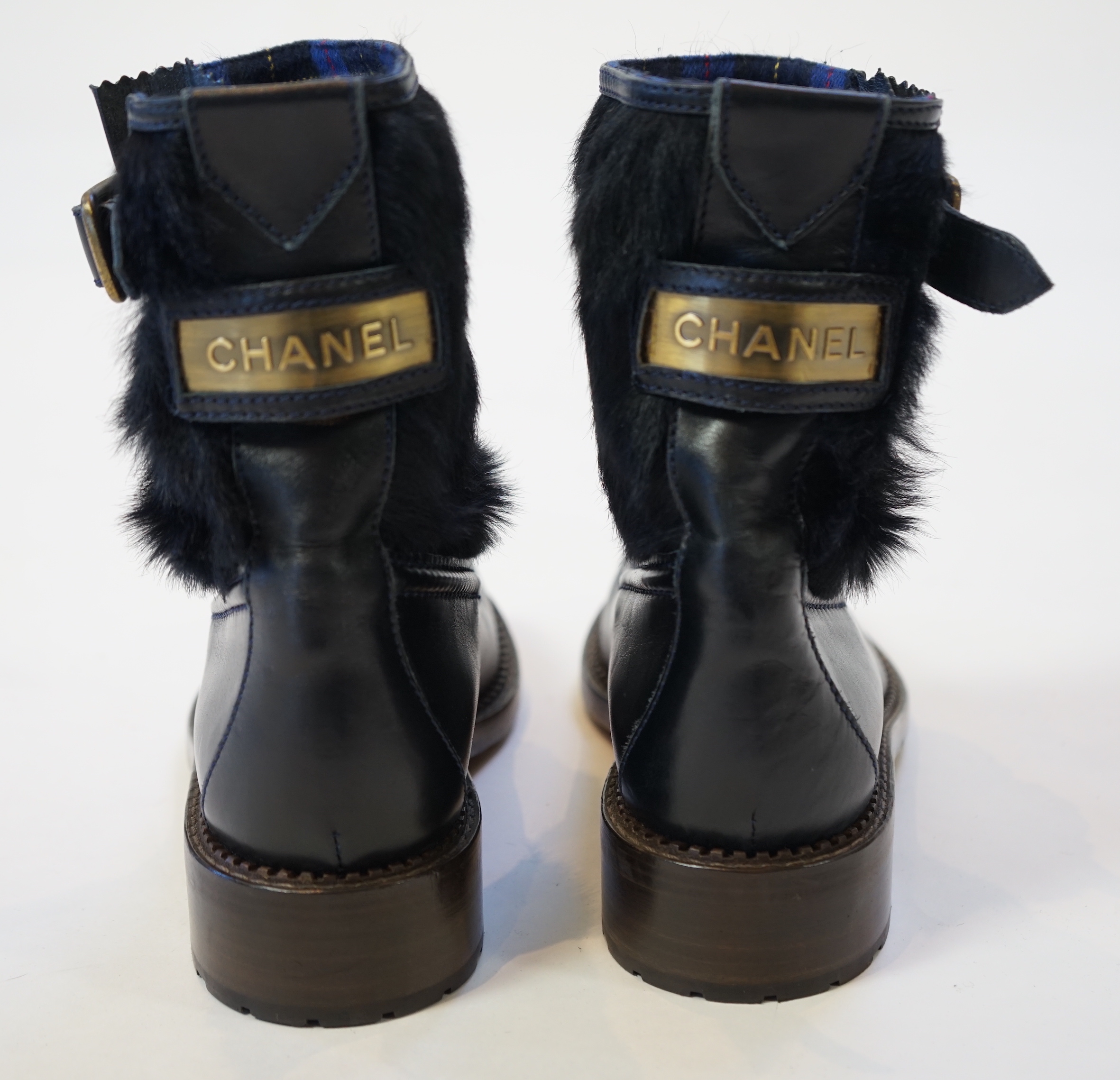 A pair of Chanel lady's navy blue leather calf hair pleated belted buckle boots, size EU 40.5